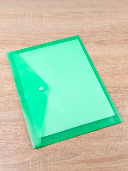 Green  Plastic Document Folder on wooden table