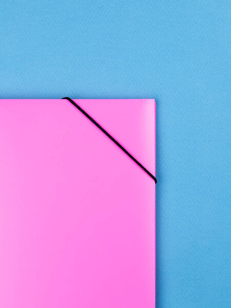 Close-up view of pink   plastic document folder on office table