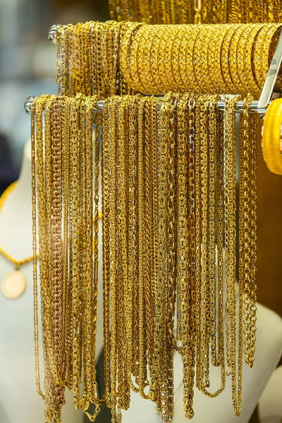 Jewelry shop window with a huge selection of gold jewelry bracelets, chains