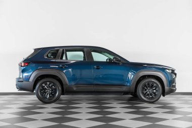 Novosibirsk, Rusya - 21 Şubat 2024: mavi Mazda CX-50 otosalonda beyaz duvara karşı, yan görüş 