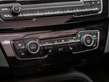 Novosibirsk, Russia - February  29 , 2024:  BMW X5, Buttons for turning on the car air conditioner on the climate control panel clipart