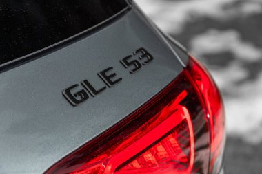  Novosibirsk, Russia -  March 31, 2024: Mercedes-Benz GLE  , close-up of the logo Mercedes  GLE on the  car body  , silver  car.   clipart