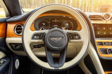 Novosibirsk, Russia -  May 01  , 2024:  white Bentley Bentayga  ,   interior details, driver's seat. Beige leather interior. clipart