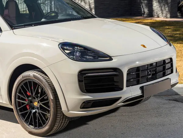 stock image Novosibirsk, Russia -  April 30  , 2024:   white Porsche Cayenne,  car with clear light headlight, bumper,  foglights