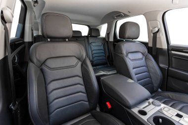 Novosibirsk, Russia -  April 13  , 2024: gray  Volkswagen Touareg , Close-up    black  leather   passenger seats. Luxury car interior clipart