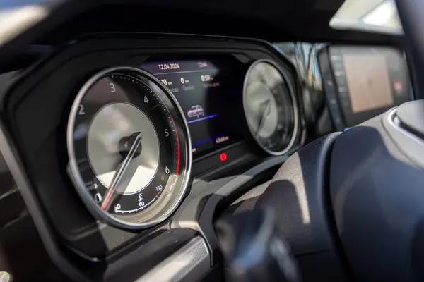 stock image Novosibirsk, Russia -  April 13  , 2024: gray  Volkswagen Touareg , close-up of the dashboard, speedometer and tachometer with white backlight. modern car interior