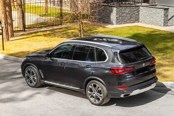 stock image Novosibirsk, Russia -  May 15, 2024: black   BMW X5  parked on the street on a  summer day against the backdrop of  city ,  back  view