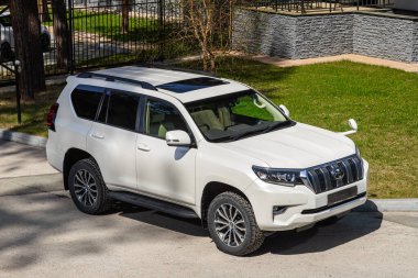 Novosibirsk, Rusya - 15 Mayıs 2024: Beyaz Toyota arazi kruvazörü yaz mevsiminde park halinde.