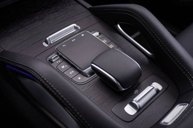 Novosibirsk, Russia -  June 01, 2024: Mercedes-Benz GLS, Close up of the manual gearbox transmission handle. Accelerator handle and buttons in a new car.  clipart