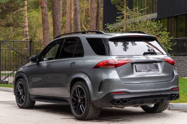 Novosibirsk, Russia -  June 01, 2024:  gray Mercedes-Benz GLE  AMG 63  parked in  park in summer  time,   back  view clipart