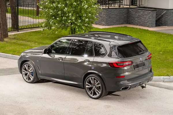 stock image Novosibirsk, Russia -  July 10, 2024: BMW X5, back view.  SUV car  against park in  summer time 