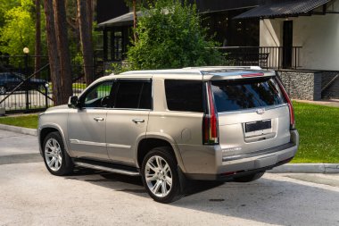 Novosibirsk, Rusya - 10 Temmuz 2024: Cadillac Escalade, sıcak bir yaz gününde park alanına park etti 