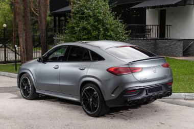 Novosibirsk, Russia -  July 10, 2024: Mercedes GLE 63 AMG Coupe,  parked on the street on a warm summer day against the backdrop of  park  clipart