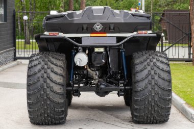 Novosibirsk, Russia -  July 10, 2024: ATV Venom, parked on the street on a warm summer day against the backdrop of  park  clipart