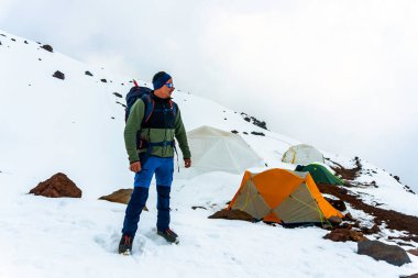 Bacborazo yanardağının yüksek kampında bir dağcı.
