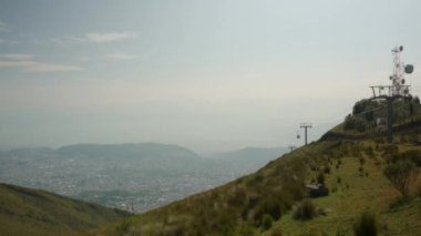 a Cable car system on the Pichincha volcano named Teleferiqo with the skyline of Quito, Ecuado