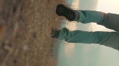 young man wearing jacket and backpack on trek trip outdoor in mountains. High quality 4k footage