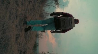 unrecognizable man with a laptop walking at sunset. High quality 4k footage
