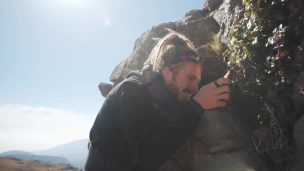 Man Photographing Plants His Phone Mountains — Stockvideo