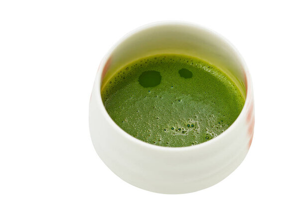Isolated Matcha green tea in a traditional Japanese design cup or bowl on white background, view from 45 degree above the hot Matcha green tea.