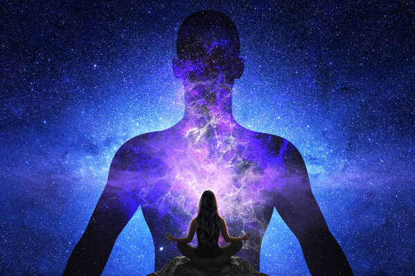 Woman doing yoga in front of giant silhouette of man with universe