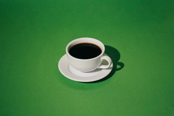 cup of coffee on green background