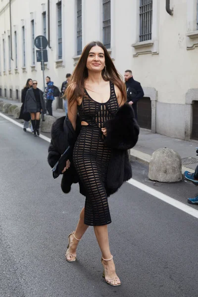stock image MILAN, ITALY - FEBRUARY 23, 2023: Natalia Bonifacci with black pierced dress and fur coat before Genny fashion show, Milan Fashion Week street style