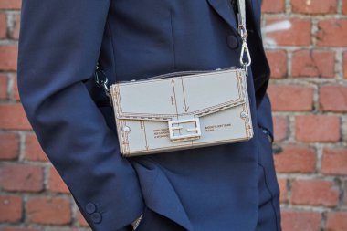 MILAN, İtalya - 13 Ocak 2024: Fendi defilesinden önce bej çantalı, mavi ceketli ve pantolonlu adam, Milan Moda Haftası tarzı