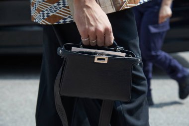 MILAN, İtalya - 15 Haziran 2024: Fendi moda defilesinden önce siyah deri çantalı adam, Milan Moda Haftası tarzı