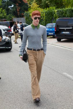 MILAN, İtalya - 15 Haziran 2024: Fendi moda defilesinden önce bej kadife pantolonlu ve gri kazaklı adam, Milan Moda Haftası tarzı