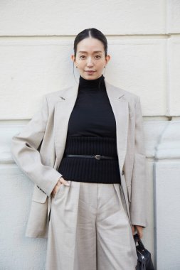 MİLAN, İTALYA 19 Eylül 2024: bej ceketli, pantolonlu ve siyah balıkçı yakalı Hana Matsushima Max Mara moda defilesinden önce, Milano sokak tarzı