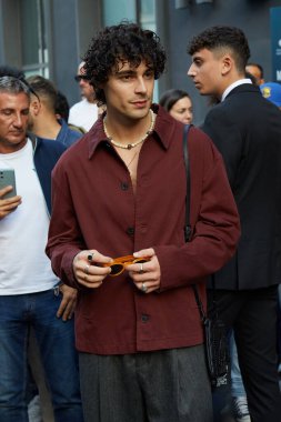 MILAN, ITALY - SEPTEMBER 20, 2024: Vittorio with burgundy shirt before Elisabetta Franchi fashion show, Milan street style clipart