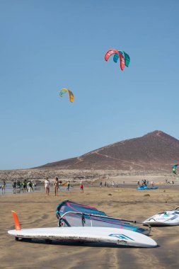 El Medano, Tenerife, Canary Islands, Spain - August 21, 2020: windswept destination for tourists enjoying a day on the beach practicing watersports, mostly kite surfing, wind surfing or water boarding