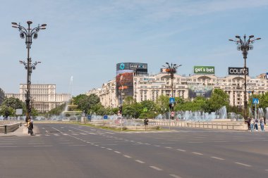 Piata Unirii, Bucuresti, Romanya - 3 Haziran 2023: Başkent merkezindeki cadde manzarası ünlü Parlamento Sarayı, çeşmeler ve yeşil alanlar gibi binalarla dolu.