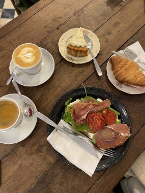 Masada tam bir kahvaltı manzarası. İki fincan kahve, tost ve kruvasan.