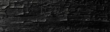 Dark black background of rough burnt wood, soot, and ash. Burn texture. clipart