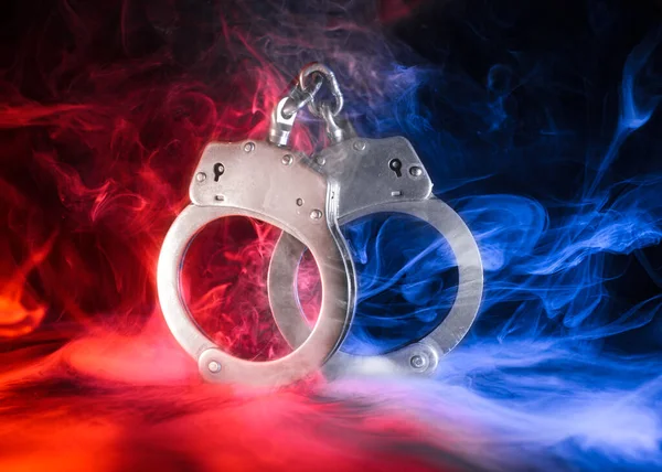 Pair Locked Handcuffs Red Blue Smoke Stock Photo