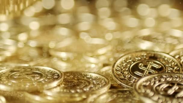 Glänsande Guldmynt Som Faller Med Glittrande Guldstoft Symboliserar Rikedom Förmögenhet — Stockvideo