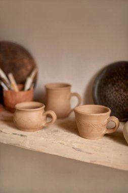 pottery workshop or work place of potter or ceramist with clay dishes - travel souvenir