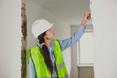 woman Industrial engineer in High-Visibility vest check and inspect in construction site