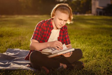 Genç çocuk parkta öğreniyor. okul konseptine geri dön