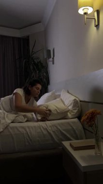 Kadın gece yatak odasında uyumaya hazırlanıyor.