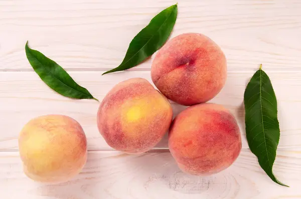 Ripe juicy peaches on white background. Summer peach fruit background.