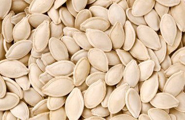 Arka plan olarak birçok kabak çekirdeği, üst manzara. Sonbahar titreşimli yiyecek kavramı, balkabağı, kabak çekirdeği