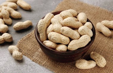 Gri masadaki bir kasede organik çiğ fıstık. Doğal besin organik gıda..