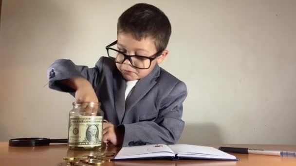 Confused Boy Suit Finding Crayon Savings Jar Dropping Desk High — Stock Video