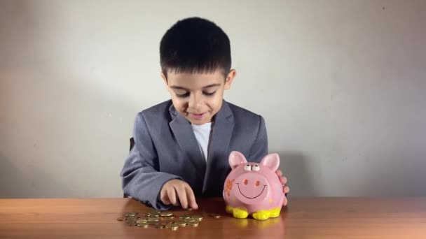 Cute Kid Suit Kissing His Piggy Bank Puts Coin Savings — Stock Video