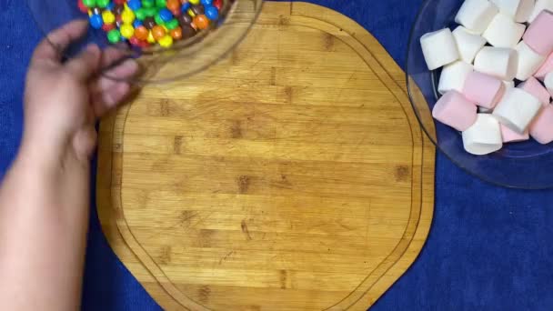 Putting Transparent Plate Full Colorful Candies Wooden Board Marshmallow Top — Stock Video