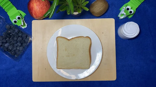 Toast bread on a white plate. Childrens breakfast preparation. High quality photo