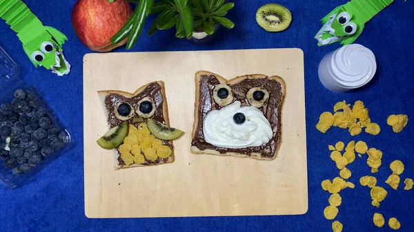 Creative kids breakfast. Food art. Owl and bear, animal shaped chocolate spread. High quality photo
